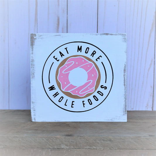 Rustic, fun, and sassy kitchen sign with colorful doughnut dessert design that says eat more whole foods..